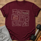 Maroon t-shirt with stamp-like graphics of gym equipment and "UNDER MILD PROTEST TRAINING."