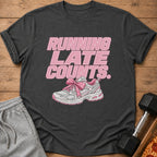 T-shirt with pink text "RUNNING LATE COUNTS" and a pink-bowed sneaker.