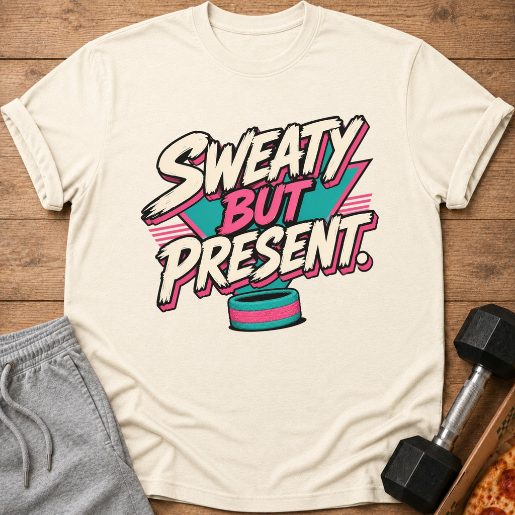 Cream t-shirt with "Sweaty But Present" text in retro style, dumbbell, and pizza slice.