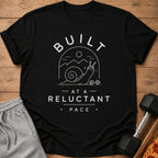Black t-shirt with white text "BUILT - AT A - RELUCTANT PACE" and a graphic.