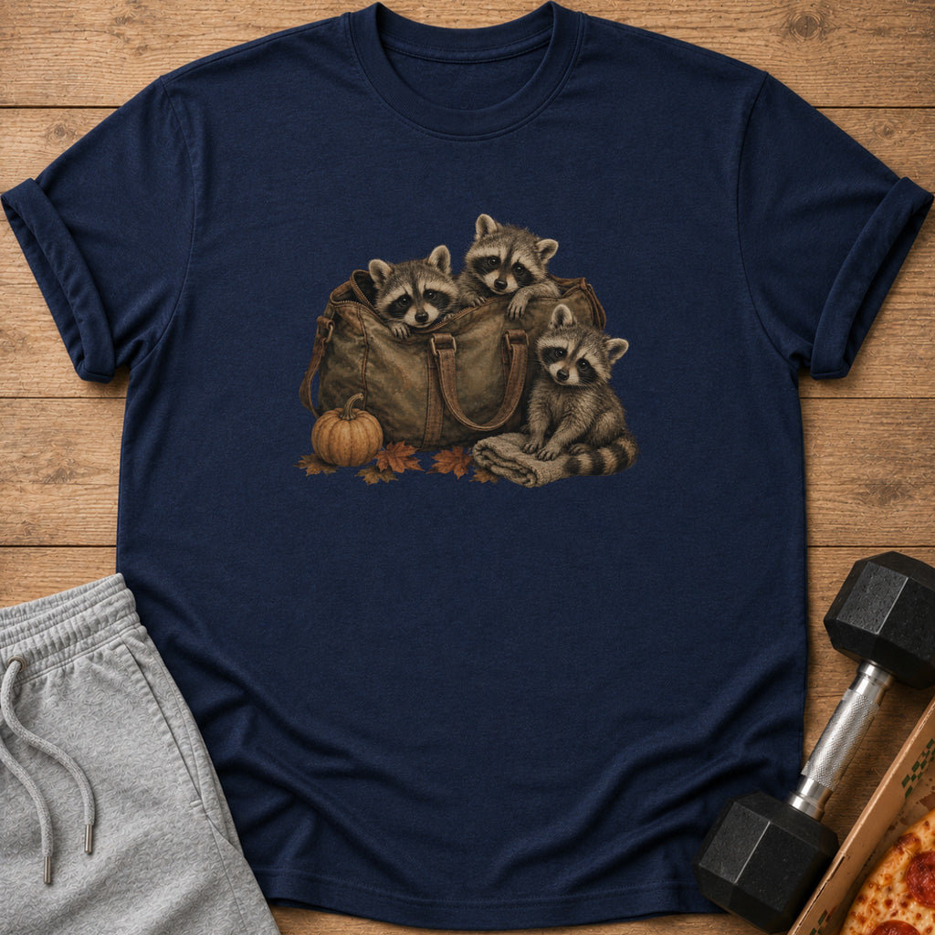 Three raccoons peeking out of a duffel bag with pumpkin and autumn leaves.