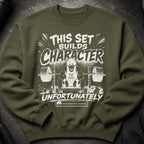 Olive green sweatshirt with "This set builds character unfortunately" text and anime character lifting weights.