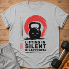 Grey t-shirt with kettlebell graphic and text "LIFTING IN SILENT DISAPPROVAL".