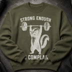 Olive green sweatshirt with distressed graphic of a chipmunk lifting a barbell, "Strong Enough" and "No Complain".