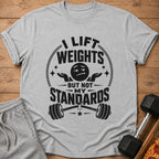 Grey t-shirt with "I Lift Weights But Not My Standards" text and barbell graphic.
