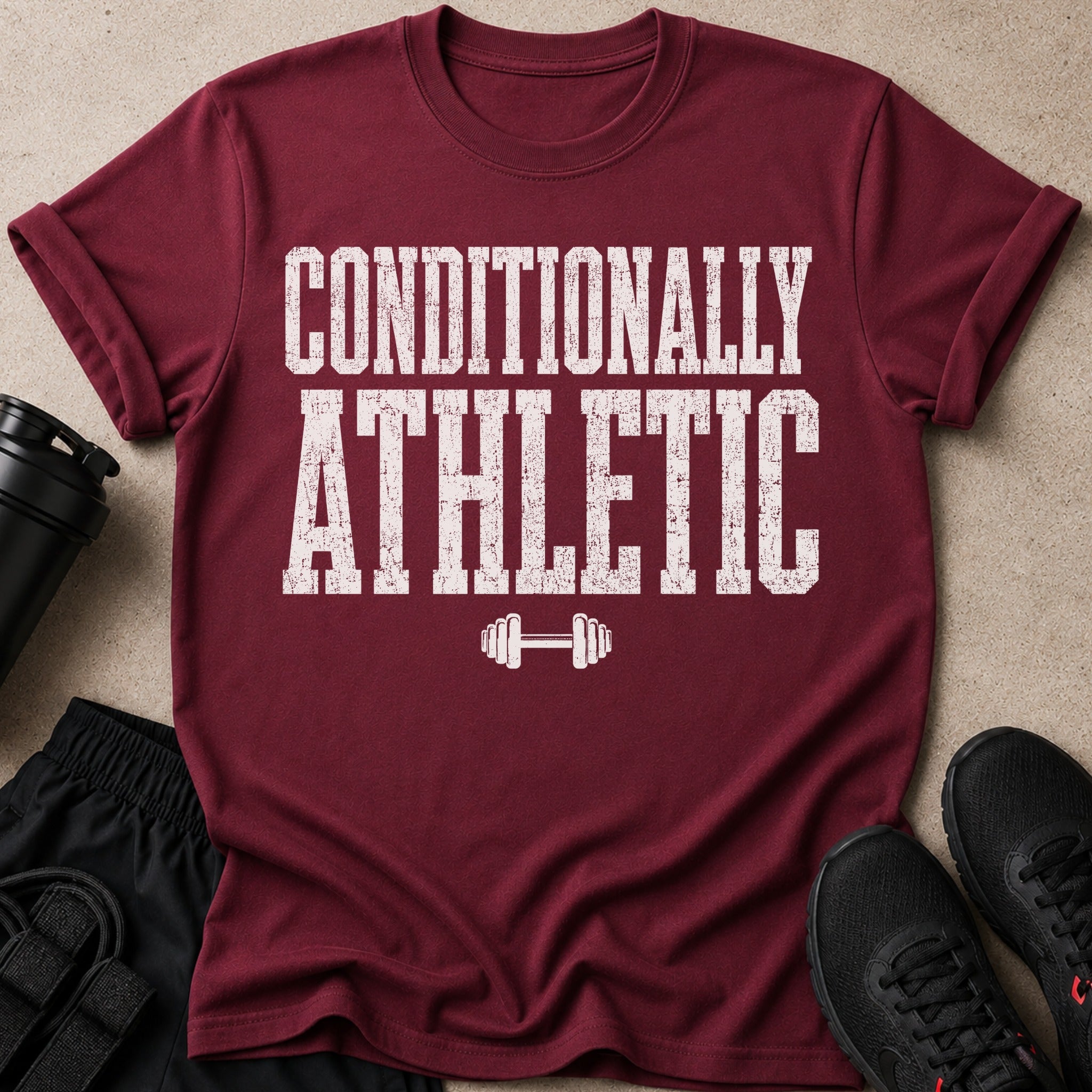 Maroon t-shirt with "CONDITIONALLY ATHLETIC" text and dumbbell graphic.
