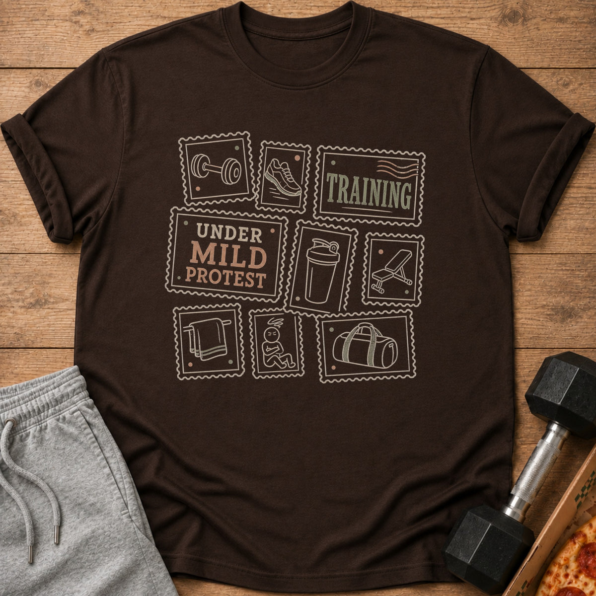 Brown t-shirt with stamps depicting fitness icons and the text "TRAINING" and "UNDER MILD PROTEST".