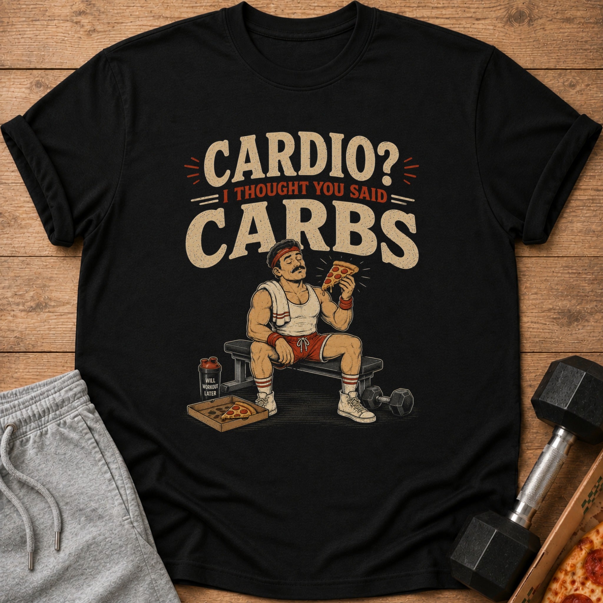 Black t-shirt with "Cardio? I Thought You Said Carbs" text and pizza-eating man illustration.
