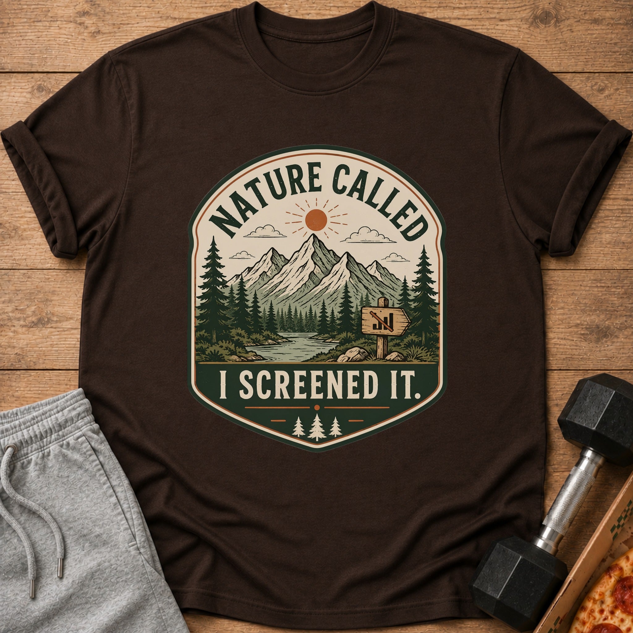 Brown t-shirt with "Nature Called I Screened It" mountain landscape graphic.