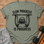 Green t-shirt with sloth graphic and text "SLOW PROGRESS IS PROGRESS".