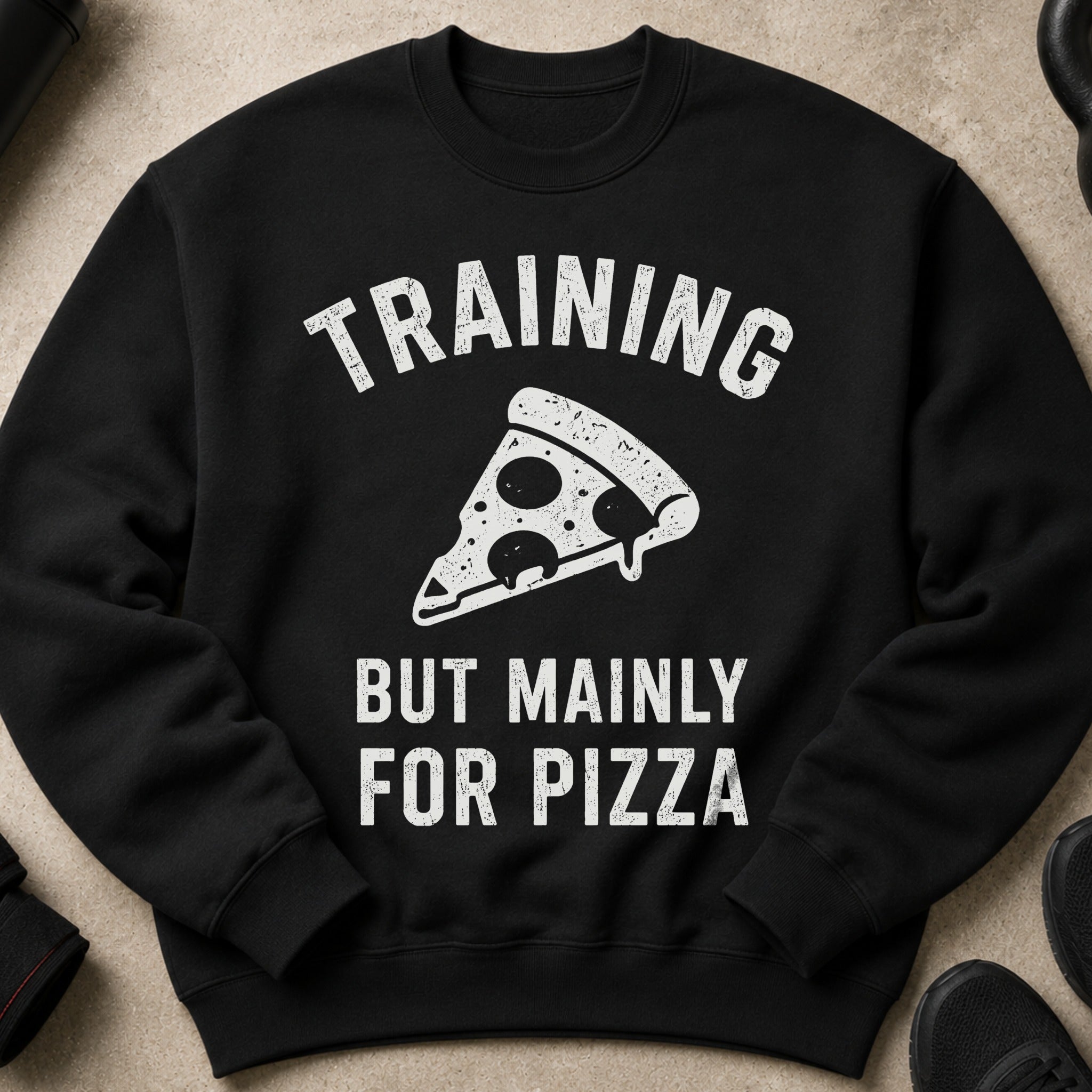 Black sweatshirt with white text and pizza graphic: "TRAINING BUT MAINLY FOR PIZZA".