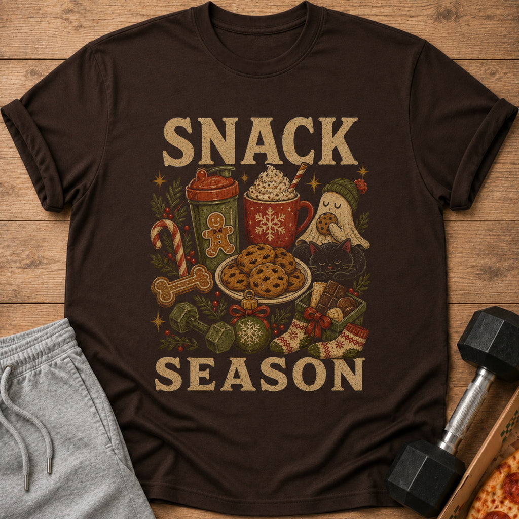 T-shirt with "SNACK SEASON" text and holiday-themed illustrations of cookies, drinks, and festive items.