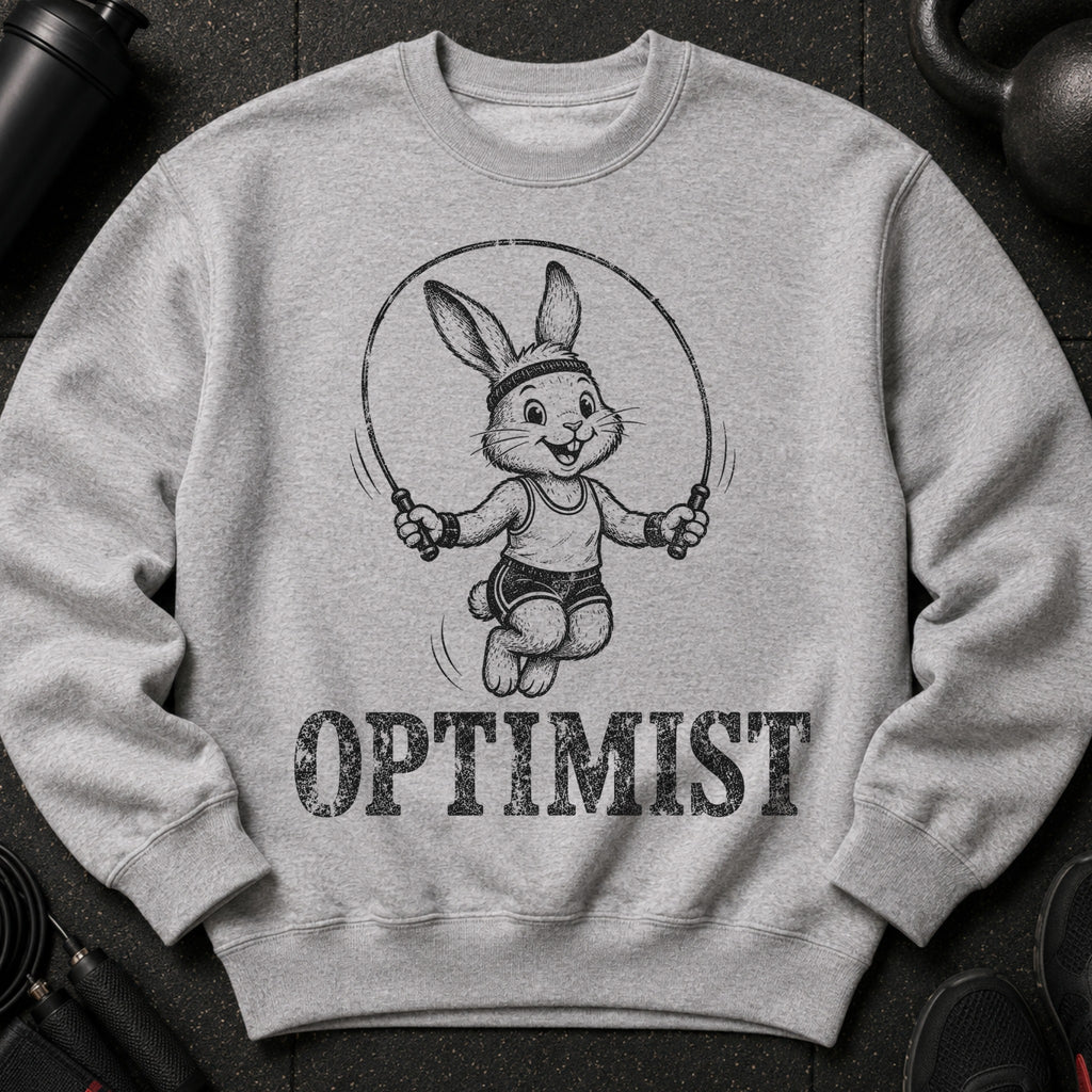 Grey sweatshirt with a drawn bunny skipping rope and the word "OPTIMIST" below.