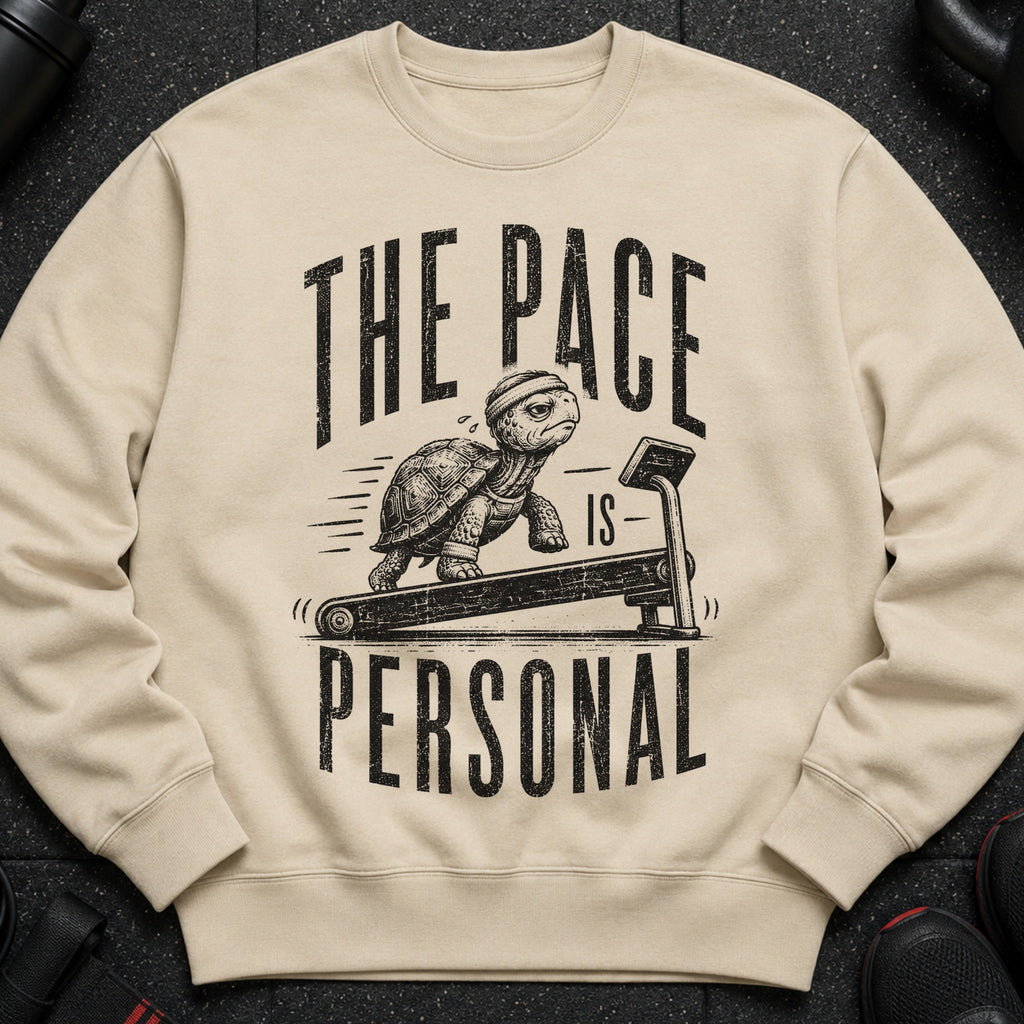 Crewneck sweatshirt with distressed graphic of a turtle on a treadmill and text "THE PACE IS PERSONAL".