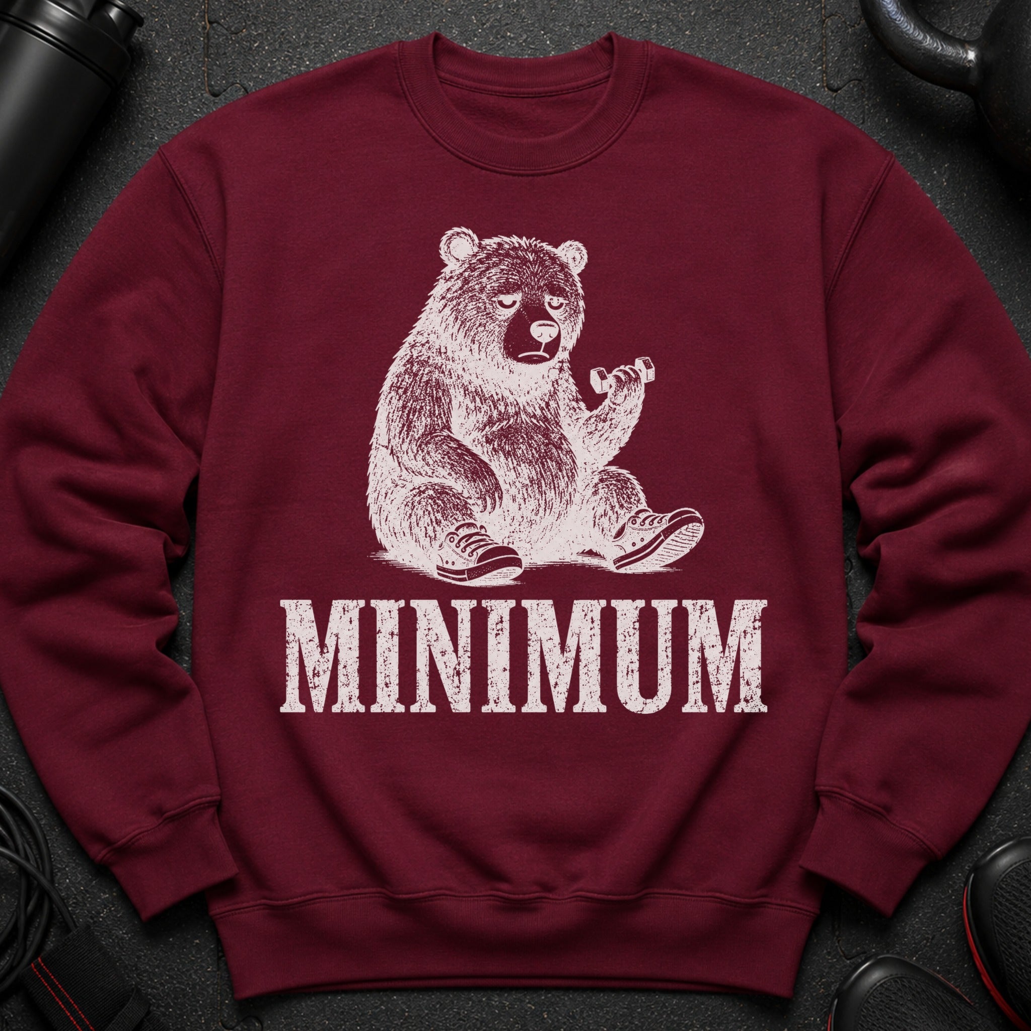 Maroon sweatshirt with distressed bear graphic holding dumbbell and text "MINIMUM".