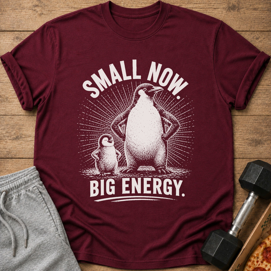 Maroon t-shirt with graphic of two penguins and text "SMALL NOW. BIG ENERGY."