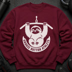 Maroon sweatshirt with white "Snooze Button Athlete" text circling a tired sloth holding a bar.