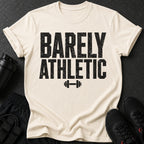 Cream t-shirt with black text "BARELY ATHLETIC" and dumbbell graphic.