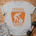 Grey t-shirt with an orange ancient Greek vase graphic of a man lifting a weight.