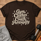 Brown t-shirt with "Gym Clothes Couch Personality" text and dumbbell graphic.