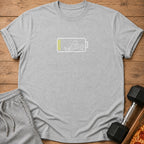 Light grey t-shirt with a graphic of a low battery and a stick figure lifting weights.
