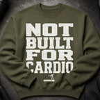 Olive green sweatshirt with white distressed text "NOT BUILT FOR CARDIO" and treadmill graphic.