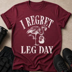 Maroon t-shirt with distressed text "I Regret Leg Day" and a flamingo holding a kettlebell.
