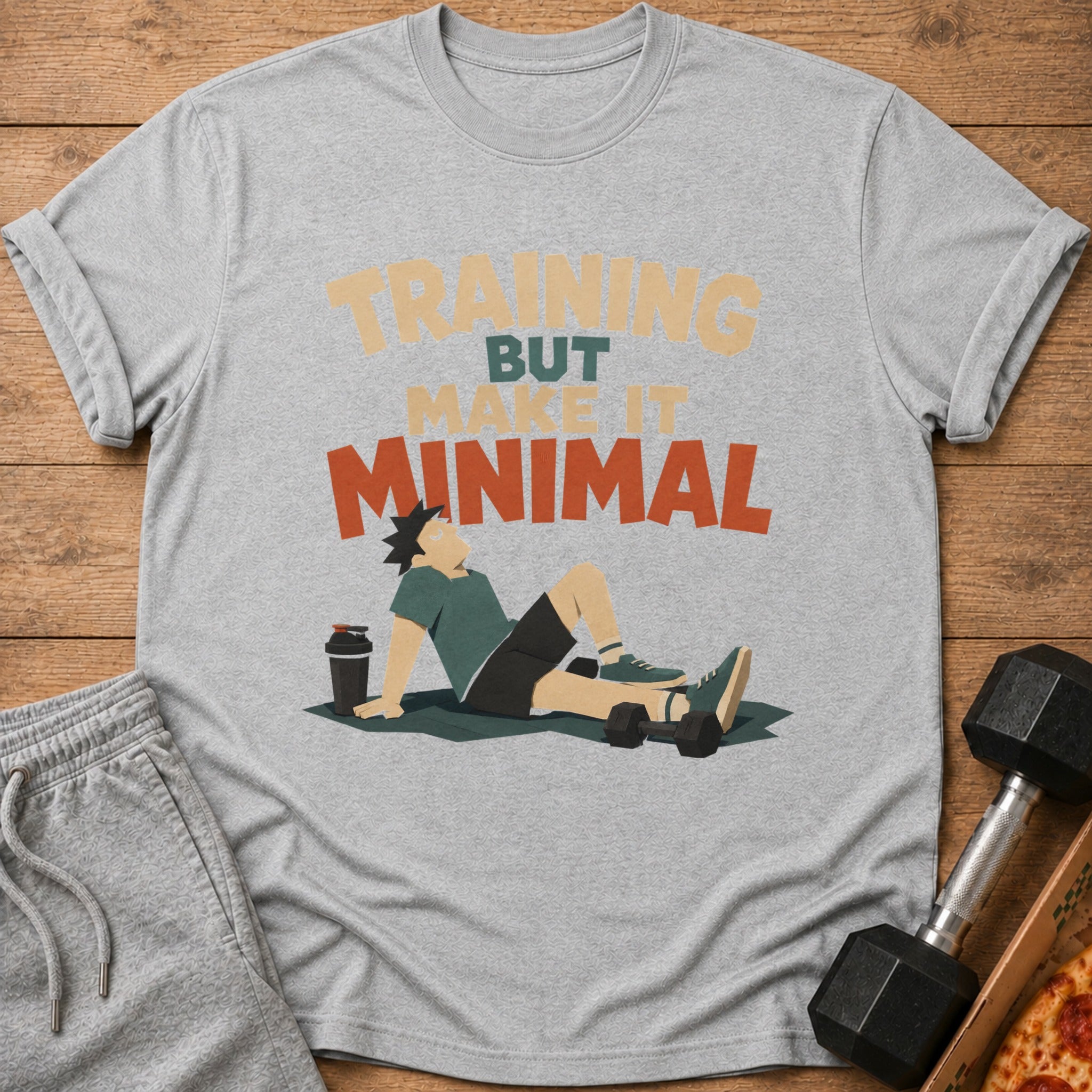 Grey t-shirt with "TRAINING BUT MAKE IT MINIMAL" text and a figure resting with weights.