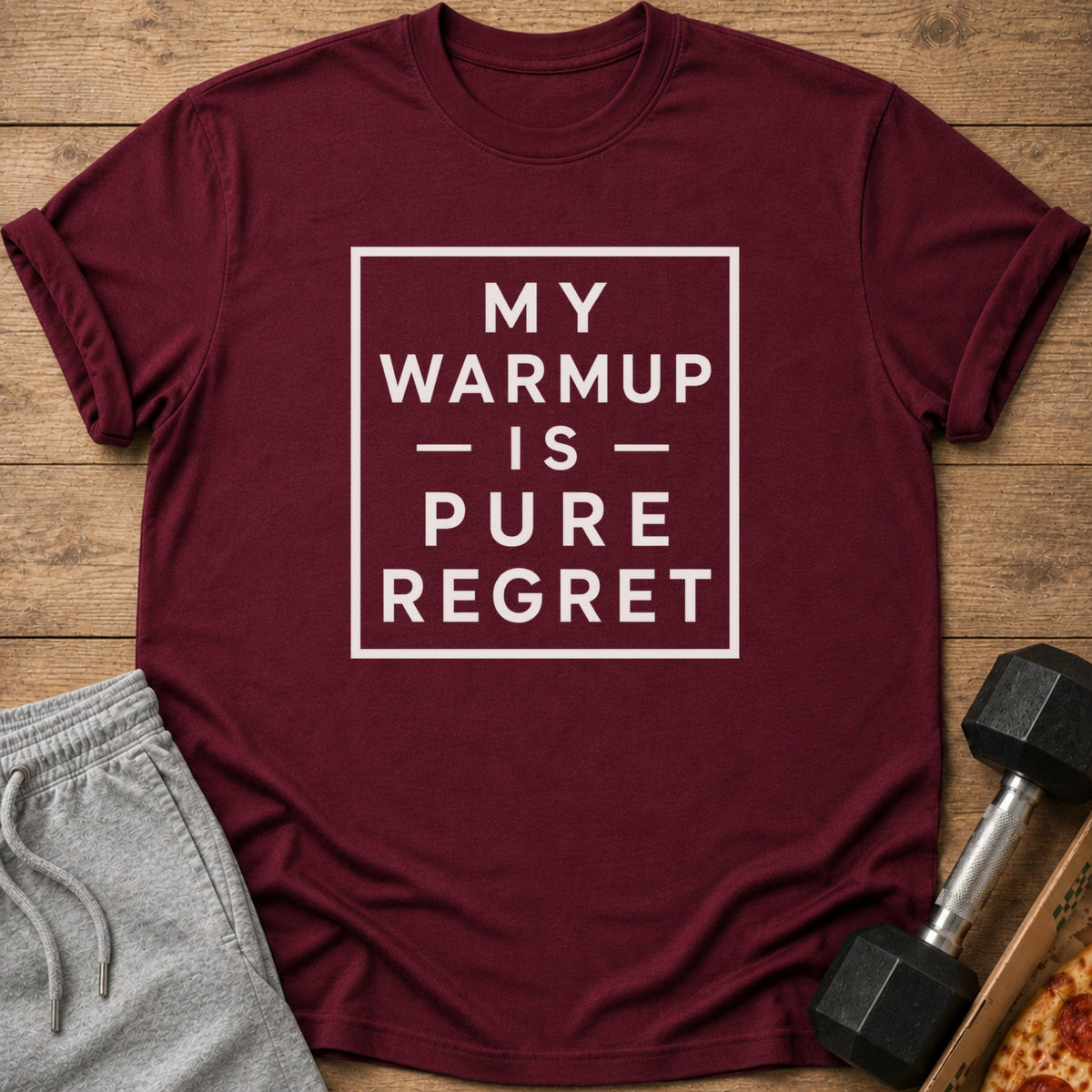 Maroon t-shirt with white text "MY WARMUP IS PURE REGRET" inside a square.