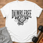 White t-shirt with "DUMBEE" text and a cartoon bee lifting dumbbells.
