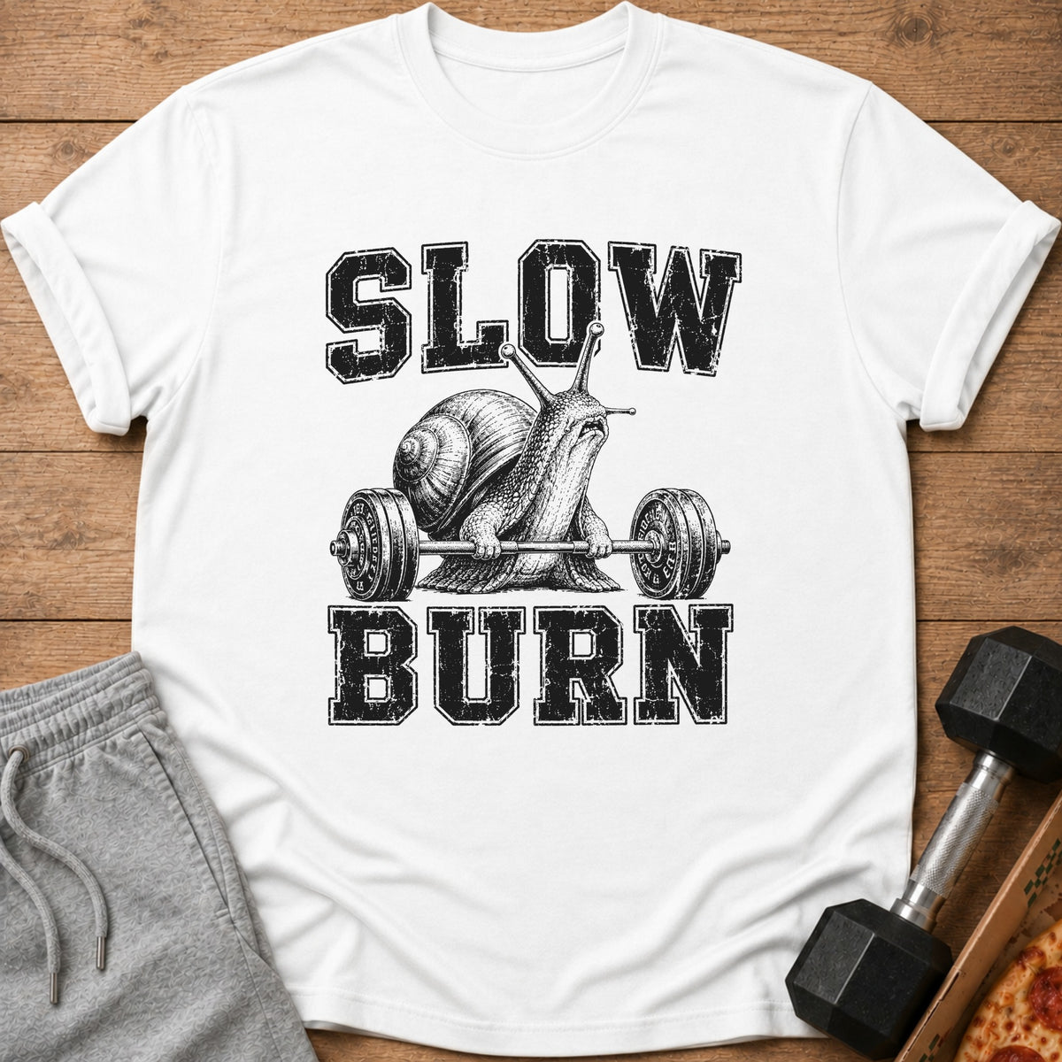 White t-shirt with a snail lifting a barbell, text reads "SLOW BURN".