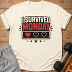 Cream t-shirt with "I Survived Monday" graphic and pixelated hearts.
