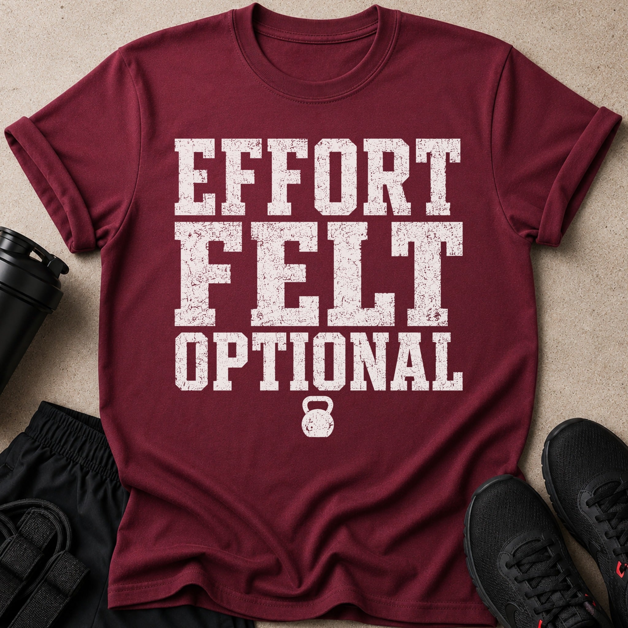 Maroon t-shirt with white distressed text "EFFORT FELT OPTIONAL" and a kettlebell graphic.