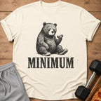 Cream t-shirt with graphic of tired bear lifting dumbbell and text "MINIMUM".