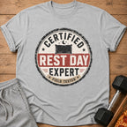Grey t-shirt with "Certified Rest Day Expert Field Tested" text and a pillow graphic.
