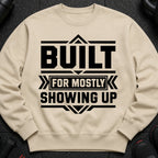 Cream sweatshirt with black text "BUILT FOR MOSTLY SHOWING UP".