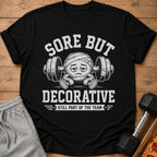 Black t-shirt with "Sore But Decorative Still Part of the Team" graphic.
