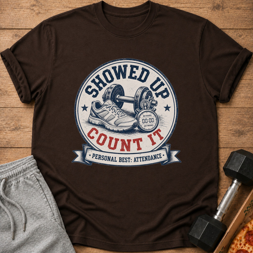 Brown t-shirt with "Showed Up Count It" graphic, gym shoe, dumbbell, and stopwatch.