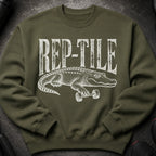Green sweatshirt with white alligator lifting dumbbells and "REP-TILE" text.