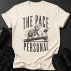 Cream t-shirt with graphic of a tortoise on a treadmill and text "THE PACE IS PERSONAL".
