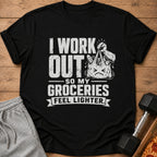 Black t-shirt with text "I Work Out So My Groceries Feel Lighter" and graphic.