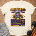 Pixel art t-shirt with kettlebell character, "Side Quest: Survive Leg Day" text.