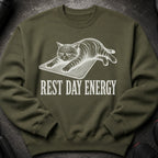 Green sweatshirt with a sketched cat and the text "REST DAY ENERGY."