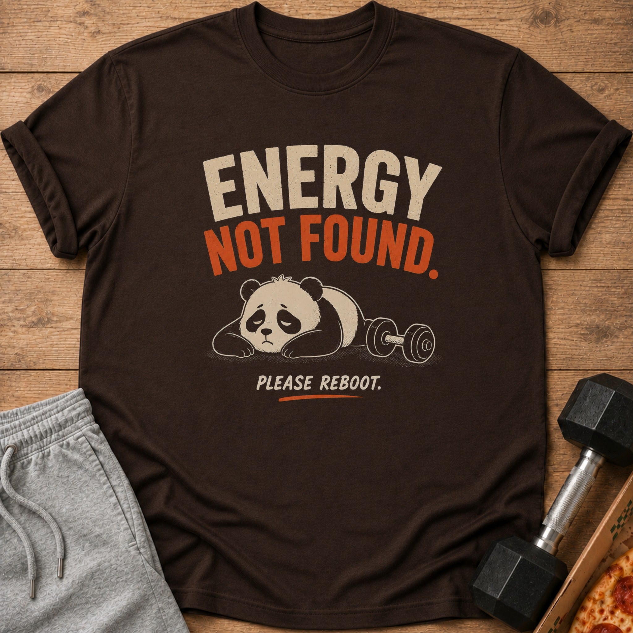 Brown t-shirt with text "ENERGY NOT FOUND. PLEASE REBOOT." and a tired panda.