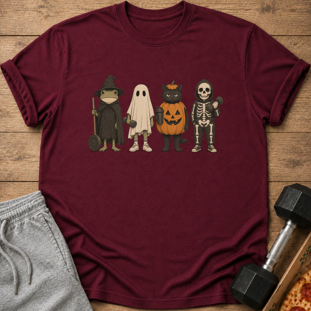 T-shirt with cartoon frog, ghost, cat, and skeleton characters in Halloween costumes.