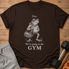 Brown t-shirt with a frog illustration and the text "Fine We're going to the GYM."