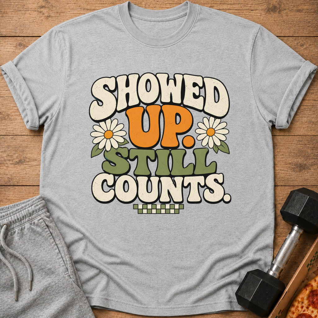 Grey t-shirt with "SHOWED UP. STILL COUNTS." text and daisy graphics.