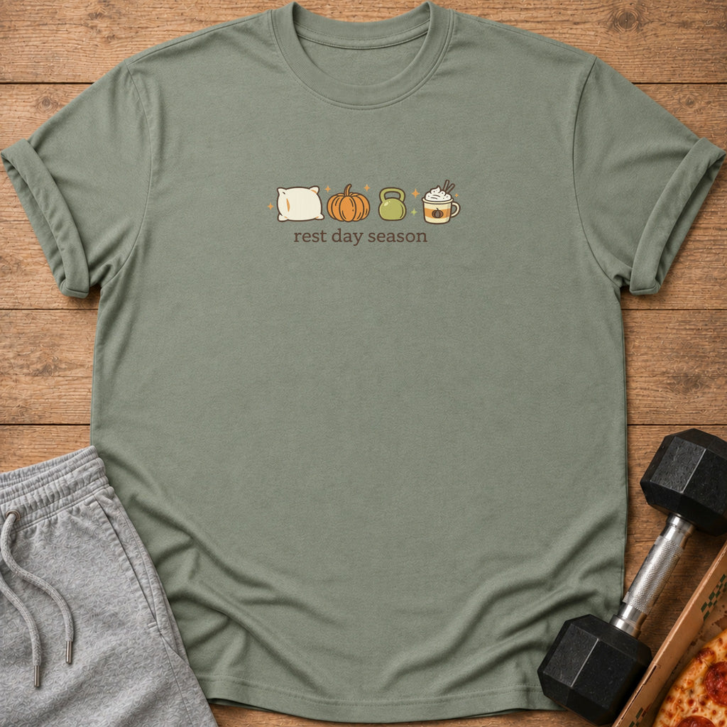 Green t-shirt with pillow, pumpkin, kettlebell, and coffee graphic and text "rest day season".