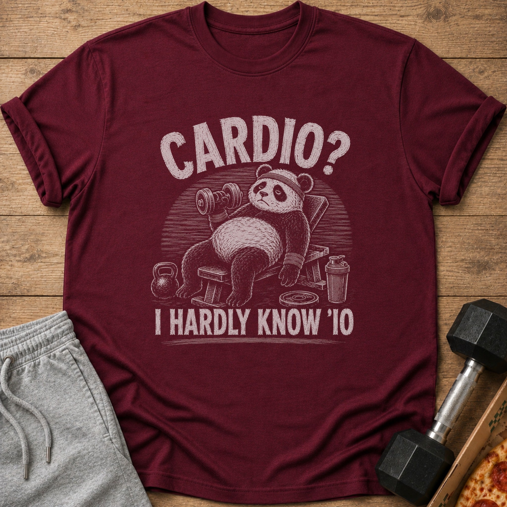 Maroon t-shirt with distressed graphic of a panda lifting a dumbbell, text "CARDIO? I HARDLY KNOW 'IO".