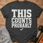 Dark gray t-shirt with white text "THIS COUNTS PROBABLY" and a checkmark.